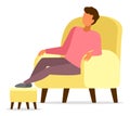 Man sitting in armchair relaxing put his feet on a special soft padded stool stand, comfort home