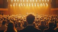 Man Sitting Among Audience Facing Illuminated Stage Royalty Free Stock Photo
