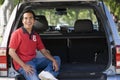 Man sitting in back of van smiling Royalty Free Stock Photo