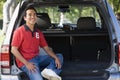 Man sitting in back of van smiling Royalty Free Stock Photo