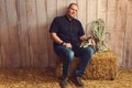 Man sitting in barn with a calico cat Royalty Free Stock Photo