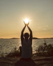 Man with raised hands catching the setting sun. Corona times appreciation of life.