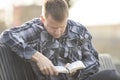 Man sitting on bench and reading bible and thinking Royalty Free Stock Photo