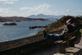 Man sitting on a bench, relaxing in the sun in Kyle of Lochalsh, Scotland.