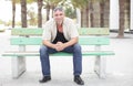 Man sitting on a bus stop bench