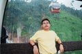 Man sitting in Cable car with Ba Na Hills Mountain in the fog. Landmark and popular. Da Nang, Vietnam and Southeast Asia travel Royalty Free Stock Photo