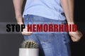 Man sitting on cactus against background, closeup. Stop hemorrhoid