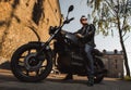 Man sitting on a cafe-racer motorcycle Royalty Free Stock Photo