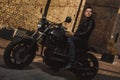 Man sitting on a cafe-racer motorcycle Royalty Free Stock Photo