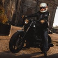 Man sitting on a cafe-racer motorcycle Royalty Free Stock Photo