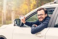 Man sitting in the car and showing his driver license Royalty Free Stock Photo