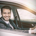 Man sitting in a car smiling and looking at camera Royalty Free Stock Photo