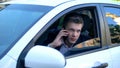 Man sitting in car, spying wife with lover, talking phone with hired killer Royalty Free Stock Photo