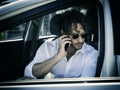 Man sitting in car talking on cell phone Royalty Free Stock Photo