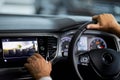 Man sitting in car and touching digital display of dashboard Royalty Free Stock Photo