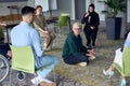 A man sitting at the center of a circle, passionately sharing his business ideas with his colleagues, fostering an Royalty Free Stock Photo