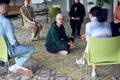 A man sitting at the center of a circle, passionately sharing his business ideas with his colleagues, fostering an Royalty Free Stock Photo