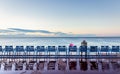 Man sitting on chair beside sea of Nice, France Royalty Free Stock Photo