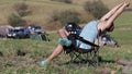 Man sitting on the chair and stretching at expeditionary camp.