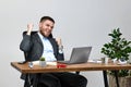 man sitting on chair at table and resting, using laptop Royalty Free Stock Photo