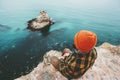 Man sitting on cliff above sea thinking Royalty Free Stock Photo