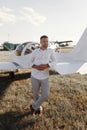 A man is sitting in the cockpit of his private plane. The pilot, against the background of the plane at sunset. Royalty Free Stock Photo