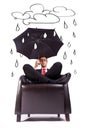 Man sitting in comfortable armchair with umbrella Royalty Free Stock Photo