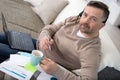 man sitting on couch studying using laptop and headset Royalty Free Stock Photo