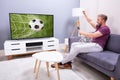 Woman Watching Soccer Game On Television