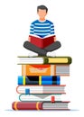 Man sitting cross-legged on stack of books