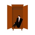 Man is sitting in cupboard. Loneliness and resentment concept. Fear