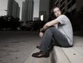 Man sitting on a curb Royalty Free Stock Photo