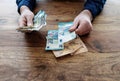 Man sitting at desk counting money Royalty Free Stock Photo