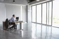 Man Sitting At Desk In Empty Office Royalty Free Stock Photo
