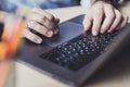 Man sitting at desk,working on laptop.Close-up male hands typing on keyboard. Businessman working on Internet.Online homebased job