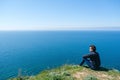 Man sitting on edge of cliff at edge Royalty Free Stock Photo