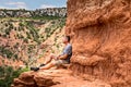 Man sitting on the edge of the Lighthouse Rock