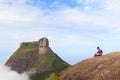 Man sitting on edge of mountain Pedra Bonita, Pedra da Gavea