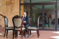 A man sitting at an empty table waiting for a meeting. Around three empty chairs Royalty Free Stock Photo