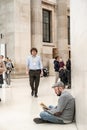 Man sitting on the floor in the Great Court of The British Museum, London Royalty Free Stock Photo