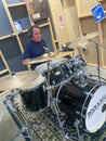 Man Sitting in Front of Drum Set at the Rock and Roll Hall of Fame Royalty Free Stock Photo