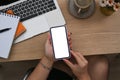 Man sitting in front of laptop computer and using smart phone. Royalty Free Stock Photo