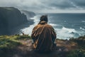 Man sitting in front of the ocean and looking at the stormy sea - Generative AI Royalty Free Stock Photo