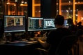 A man sitting in front of three computer monitors working on multiple tasks simultameously, Programmers Working On Software In Royalty Free Stock Photo