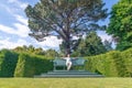 Man sitting on a giant bench, Bodnant garden, Wales