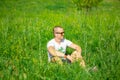 Man sitting in the grass in sunglasses