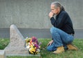 Man sitting at gravesite Royalty Free Stock Photo