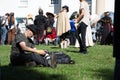 a man sitting on the ground next to a group of people