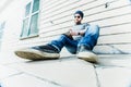 Man sitting on the ground and writing in a notebook. Royalty Free Stock Photo