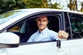 Man sitting in his car and holding keys Royalty Free Stock Photo